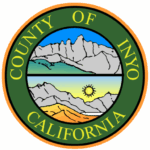 Seal of Inyo County, California, with mountains, blue sky, and sun in the center.